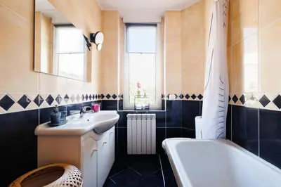 a bathroom with a sink and a toilet and a tub at Sunwave with Terrace 280 Mbps Old Town Renovated in Belgrade
