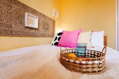 a bedroom with a bed with a basket with a glass at Sunwave with Terrace 280 Mbps Old Town Renovated in Belgrade
