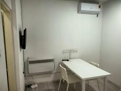 a white room with a table and a air conditioner at B and S apartment 2 in Belgrade
