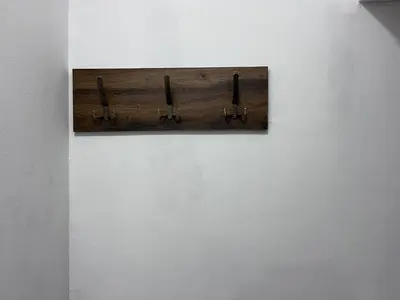 a wooden clipboard hanging on a wall at The Cozy George Apartment in Belgrade