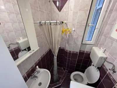 a bathroom with a toilet and a sink at The Cozy George Apartment in Belgrade