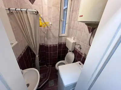 a small bathroom with a toilet and a sink at The Cozy George Apartment in Belgrade