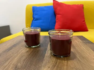two glasses of chocolate on a wooden table at The Cozy George Apartment in Belgrade