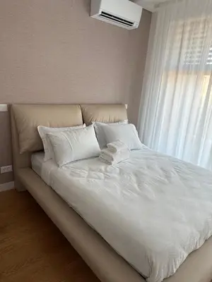 a large bed with white sheets and a window at Landmark Premium Lux Apartment in Želenička Stanica Beograd Sava