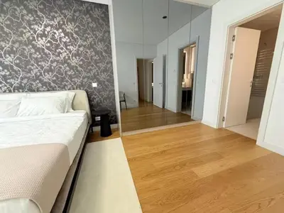 a living room with a bed and a large mirror at Landmark Premium Lux Apartment in Želenička Stanica Beograd Sava