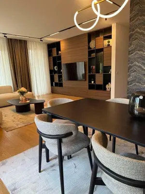a living room with a dining table and chairs at Landmark Premium Lux Apartment in Želenička Stanica Beograd Sava