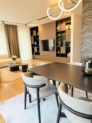 a living room with a dining table and chairs at Landmark Premium Lux Apartment in Želenička Stanica Beograd Sava