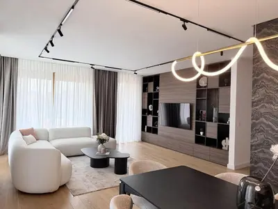 a living room with a white couch and a table at Landmark Premium Lux Apartment in Želenička Stanica Beograd Sava