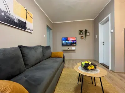 a living room with a couch and a table at Apartman Momirov Titel