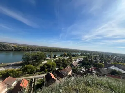 arial view of a small town with a lake at Apartman Momirov Titel