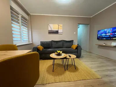 a living room with a couch and a table at Apartman Momirov Titel