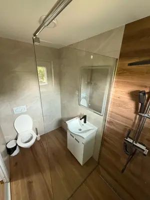 a bathroom with a toilet and a sink and a shower at Carigradski Drum Residence in Radinac