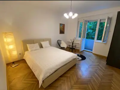 a bedroom with a large bed and a window at Belgrade Apartment Dorcol in Belgrade