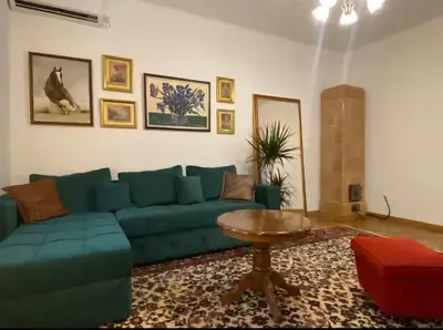 a living room with a blue couch and a table at Belgrade Apartment Dorcol in Belgrade