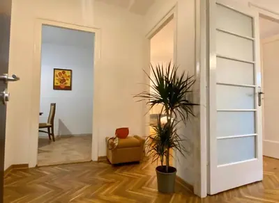 a room with a door and a chair and a plant at Belgrade Apartment Dorcol in Belgrade