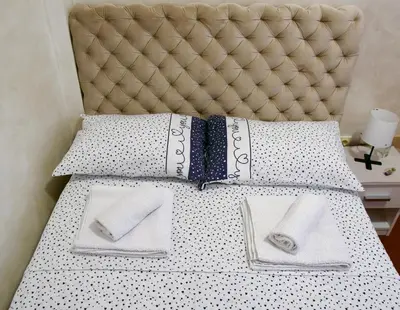 a bed with pillows and napkins on it at Apartman 11550 in Lazarevac