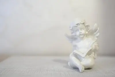 a white angel figurine sitting on a table at Apartman 11550 in Lazarevac