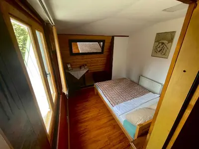 a small room with a bed and a window at Apartment Jancic in Smederevo
