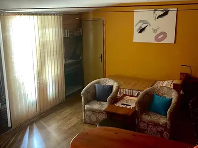 a living room with two chairs and a table at Apartment Jancic in Smederevo