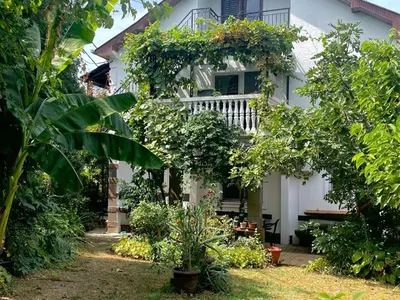 a white house with plants in front of it at Apartment Jancic in Smederevo