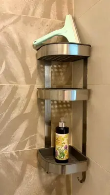 a shelf with a moisturizing bottle on a wall at Belgrade Terrace Apartment in Belgrade