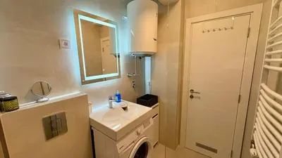 a small bathroom with a sink and a mirror at Belgrade Terrace Apartment in Belgrade