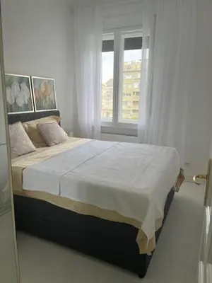 a bedroom with a large bed with a window at Park Oasis Centerpoint Residence in Belgrade