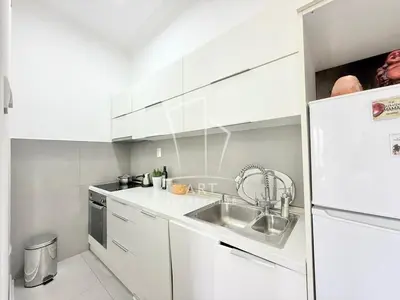 a white kitchen with a sink and a refrigerator at Park Oasis Centerpoint Residence in Belgrade