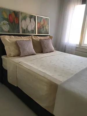 a bedroom with a large bed with two pillows at Park Oasis Centerpoint Residence in Belgrade