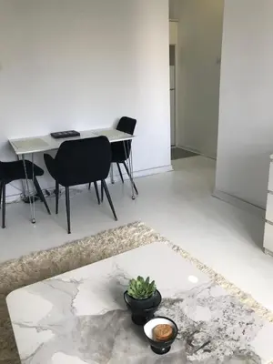 a living room with a table and chairs at Park Oasis Centerpoint Residence in Belgrade