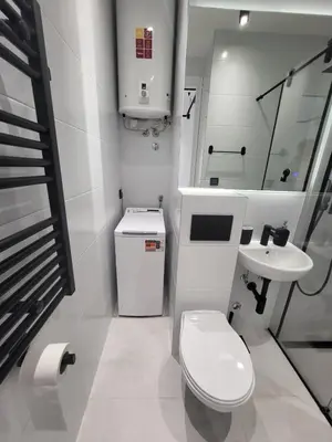 a white bathroom with a toilet and a sink at Don apartment Dorcol in Belgrade