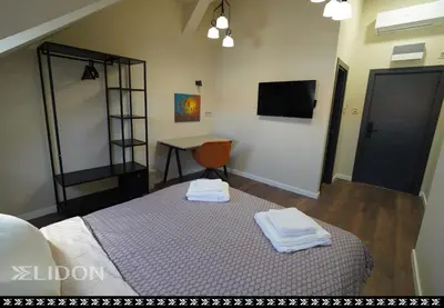 a bedroom with a bed with two towels on it at Elidon 1833 in Pančevo