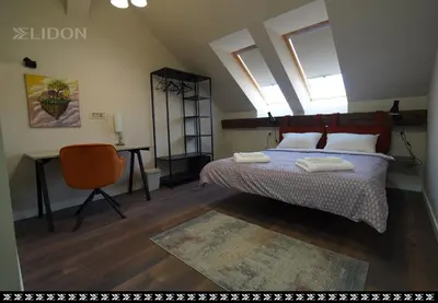 a bedroom with a bed with two towels on it at Elidon 1833 in Pančevo