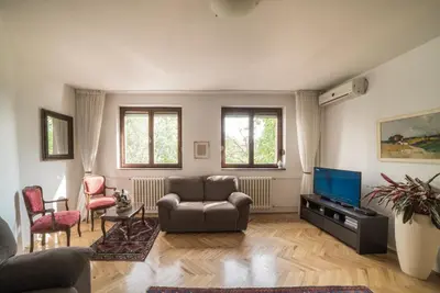 a living room with a couch and a television at Sensitive Apartment in Belgrade