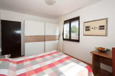 a bedroom with a bed and a window at Sensitive Apartment in Belgrade