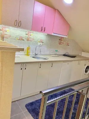 a kitchen with a sink and pink cabinets at Stay at Balkanska 45 in Belgrade