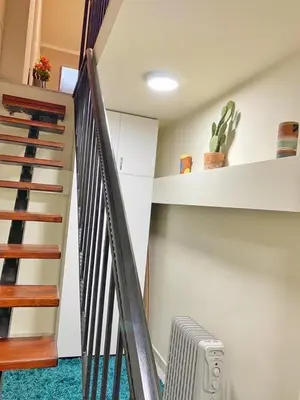 a hallway with a staircase and a stair case with a heater at Stay at Balkanska 45 in Belgrade