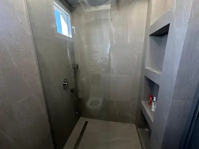 a bathroom with a shower with a glass door at Elmora Residence Vračar Južni Bulevar in Belgrade