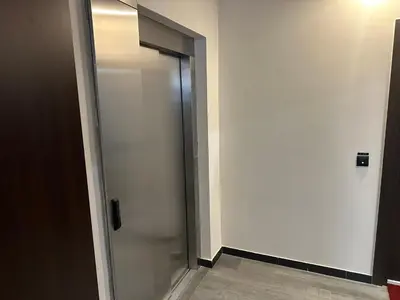 a glass elevator door in a room with a wall at Elmora Residence Vračar Južni Bulevar in Belgrade