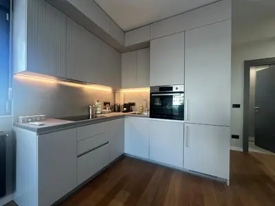 a kitchen with white cabinets and a microwave at Elmora Residence Vračar Južni Bulevar in Belgrade