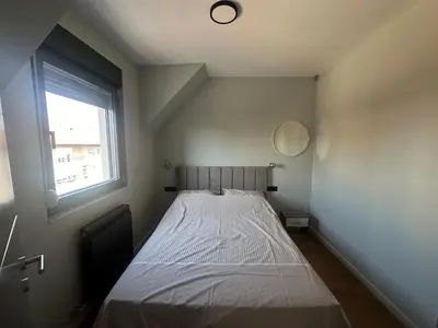 a bed in a room with a window at Elmora Residence Vračar Južni Bulevar in Belgrade