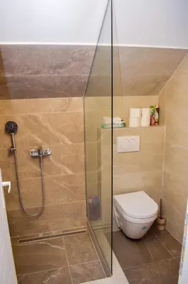 a bathroom with a shower and a toilet at Elan Apartment in Belgrade