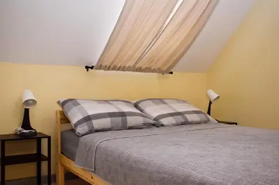 a bedroom with a bed with two pillows on it at Elan Apartment in Belgrade