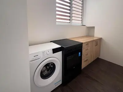 a washer and dryer in a small room at City Center Apartment in Belgrade