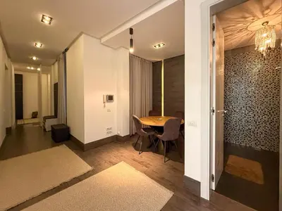 a dining room with a table and a chandelier at City Center Apartment in Belgrade