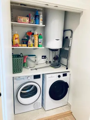 a laundry room with a washer and a washing machine at Belgrade Waterfront Kalemegdan and River View with Garage in Belgrade