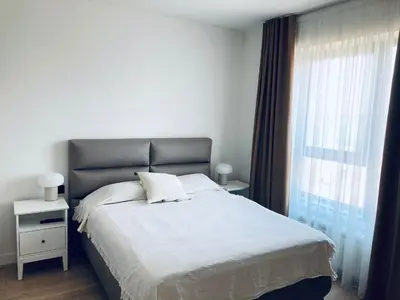 a bedroom with a large bed and a window at Belgrade Waterfront Kalemegdan and River View with Garage in Belgrade