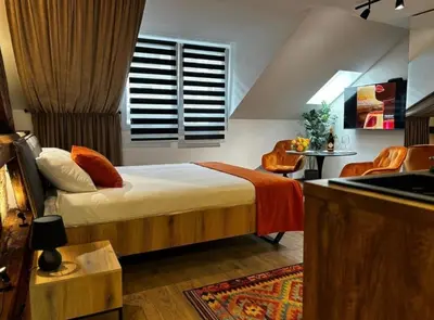 a bedroom with a bed and a window and a table at Sweet home in Belgrade