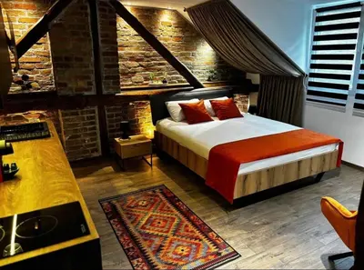 a bedroom with a bed and a brick wall at Sweet home in Belgrade