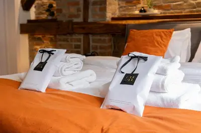 two bags of towels and towels on a bed at Sweet home in Belgrade